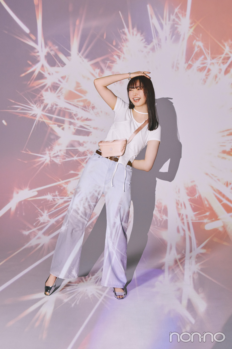 白のレイヤードトップスにデニムをはいた小宮山莉渚