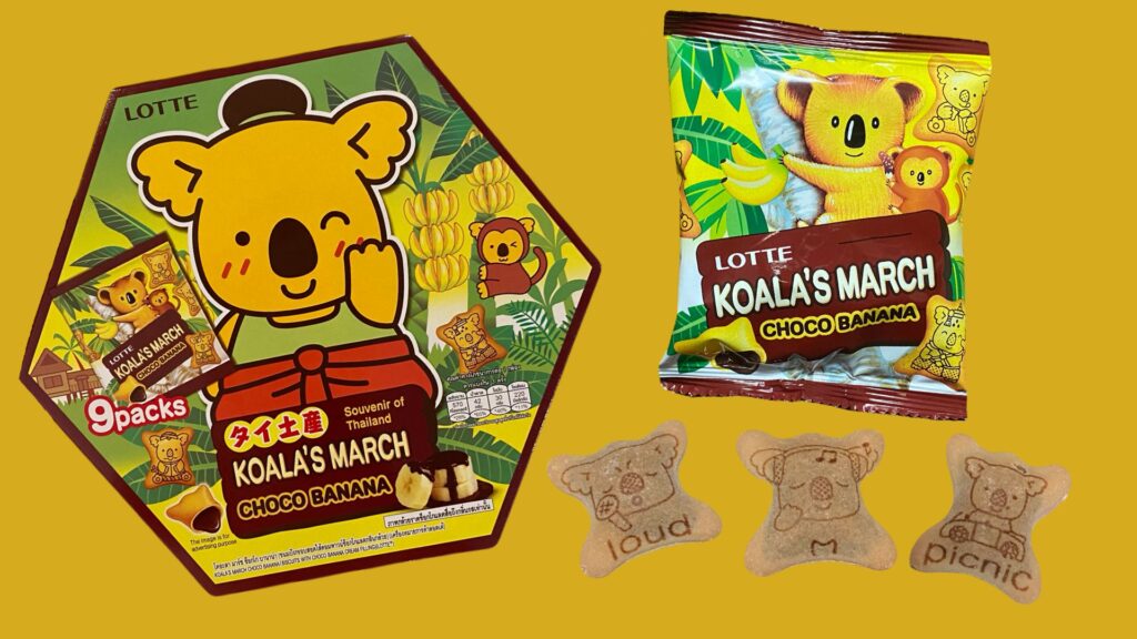 チョコバナナ味のコアラのマーチ、右上には個包装のパッケージ、右下のクッキーは左からloud、アルファベットでM、picnicと書かれている。