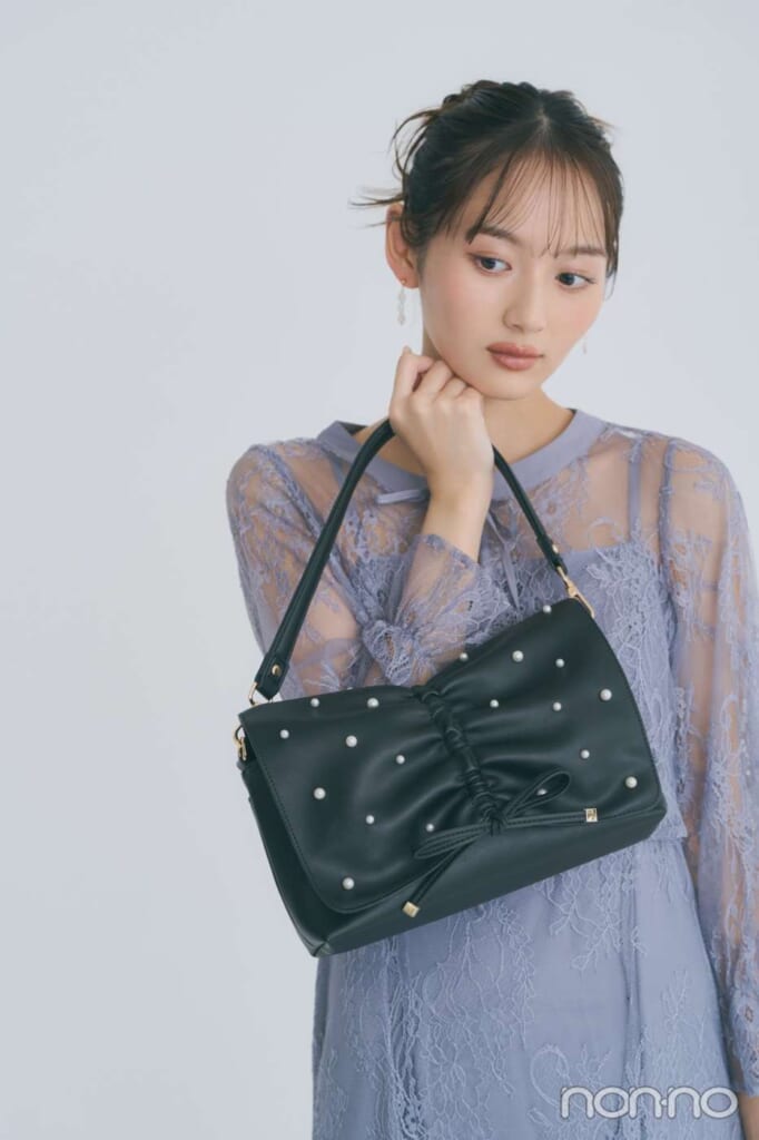 パール付きブラックのバッグを持つ加藤栞